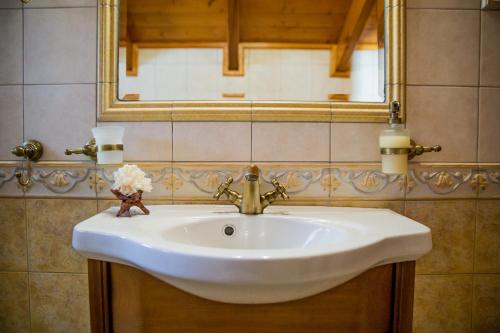 a white sink in a bathroom with a mirror at Lagonisi Villa VIP in Lagonissi