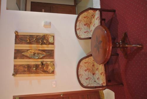 a wall with two plates on a wall at Chaikana Thani Hotel in Phatthalung