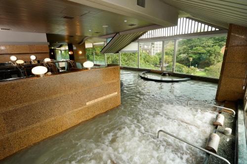 a room with a pool of water with a boat in it at Radium Kagaya Taipei in Taipei