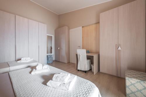 a bedroom with a bed and a desk with a chair at Villa Maria Beatrice in Quartu SantʼElena