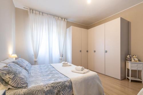 a bedroom with a bed and a large window at Villa Maria Beatrice in Quartu SantʼElena