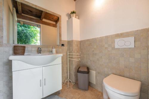 a bathroom with a sink and a toilet at Villa Maria Beatrice in Quartu SantʼElena