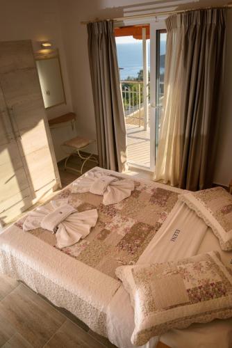 a bedroom with a bed with a view of the ocean at Eleni Studios Parga in Parga