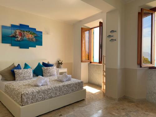 a bedroom with a bed in a room with windows at Affittacamere San Giorgio in Manarola