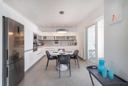 a kitchen and dining room with a table and chairs at Melia Villa Kos with Heated Pool in Kos Town