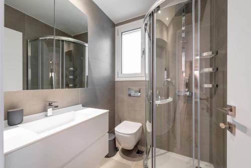 a bathroom with a toilet and a sink and a shower at Melia Villa Kos with Heated Pool in Kos Town