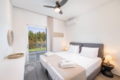 a bedroom with a bed with two towels on it at Melia Villa Kos with Heated Pool in Kos Town