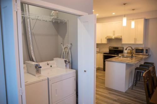 a kitchen with white cabinets and a counter top at Downtown Whitehorse 4 bedrooms deluxe condo in Whitehorse