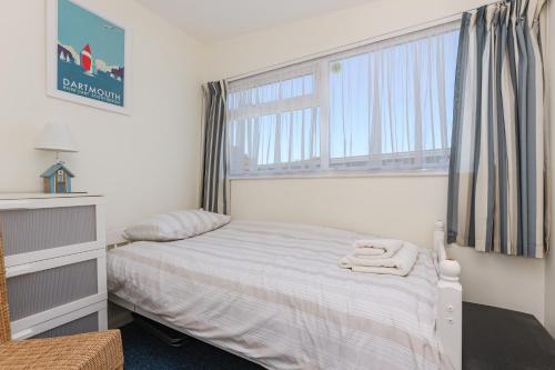 Un dormitorio con una cama y una ventana grande. en 133 Norton Park, en Dartmouth