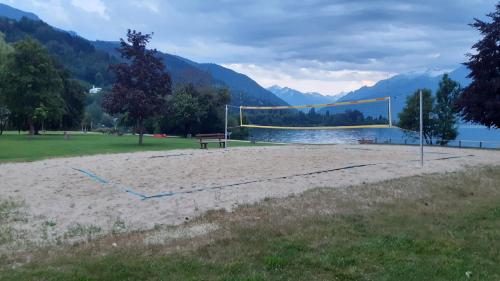 a volleyball court with a net in a field next to a lake at Wildente am See in Maishofen
