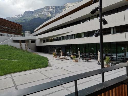 a building with a courtyard with tables and chairs at Via stenna in Flims