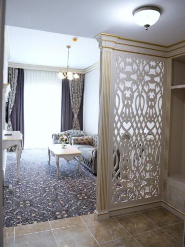 a living room with a large partition with a couch at Hotel Dacia Sud in Mamaia