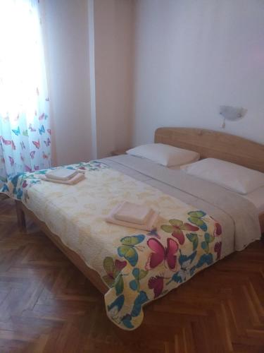 a bedroom with two beds with towels on them at Guest House Silvia in Rab