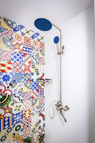 a shower in a bathroom with a shower curtain at Spring Holiday Resort in Neptun