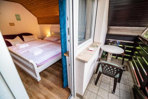 a small bedroom with a bed and a table at Home away from home in Bohinj