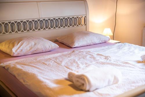 a bed with two pillows and a blanket on it at Home away from home in Bohinj