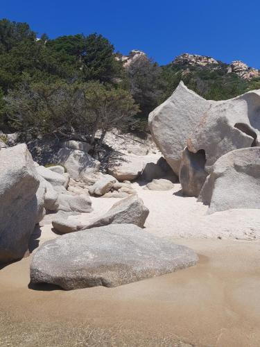 a group of large rocks on a sandy beach at Stazzo Serafini in Rena Majore