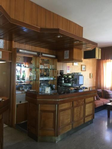 a kitchen with a wooden counter top and wooden cabinets at Hotel Sestriere in Chianciano Terme