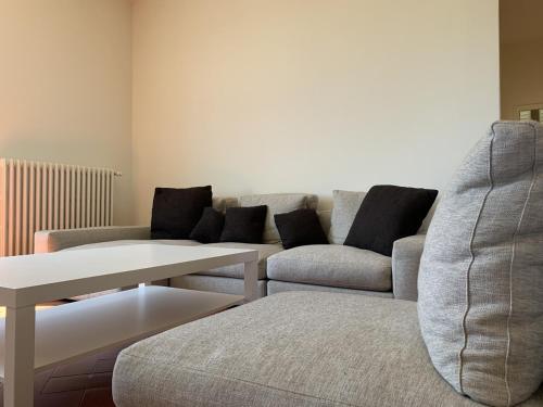 a living room with a couch and a table at Spectacular Chianti View close San Gimignano in Tavarnelle in Val di Pesa