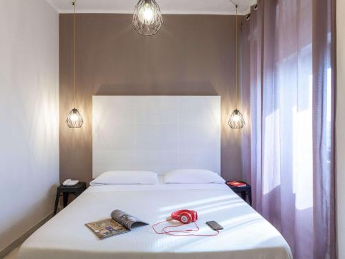 Postel nebo postele na pokoji v ubytování ibis styles Trani