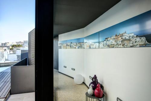 a room with a wall with a picture of buildings at Bartago Luxury House in Ostuni