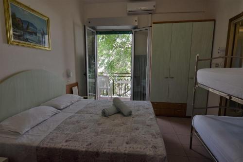 a bedroom with two beds and a large window at Hotel Everest in Bellaria-Igea Marina
