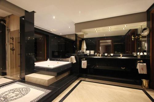 a large bathroom with a tub and a sink at Mirage Ibiza in Ibiza Town