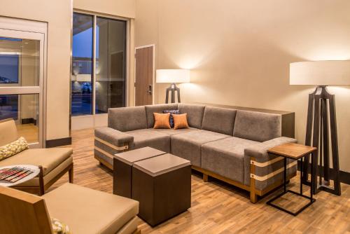 a living room with a couch and a table at Holiday Inn Joplin by IHG in Joplin