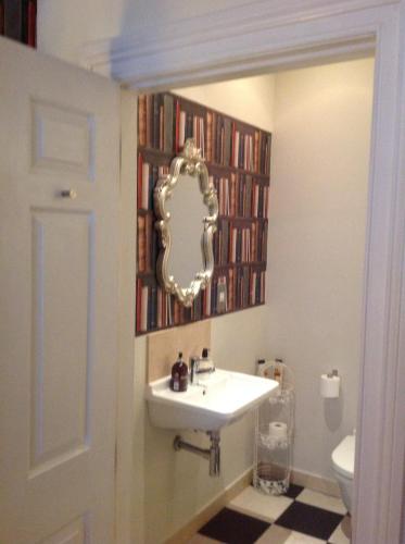 a bathroom with a sink and a mirror at A Room in the City - West in Edinburgh