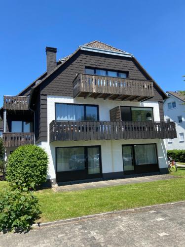 a house with a deck on top of it at Ferienwohnung Fichtenweg in Winterberg
