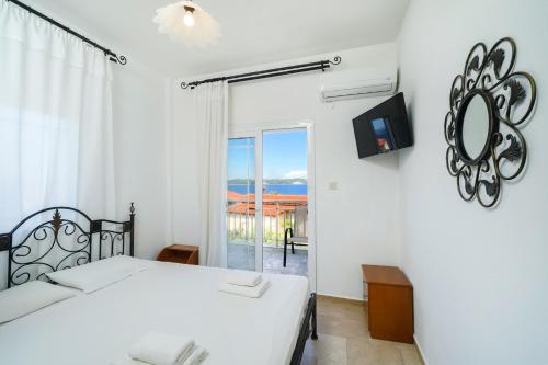 a bedroom with a bed and a view of the ocean at Studios Garifalia in Ammouliani