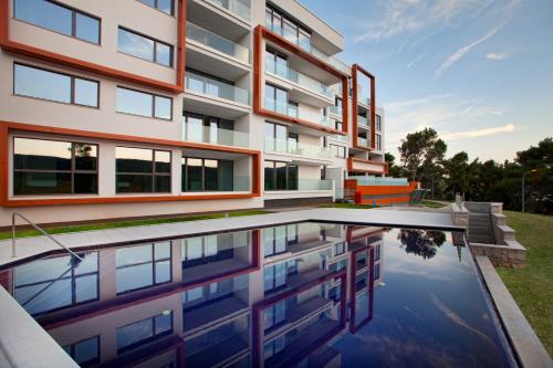 an exterior view of a building with a reflecting pool at Park Hill Residences in Rabac