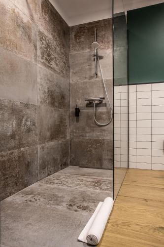 a bathroom with a shower with a glass door at OTTON-Charzykowy Bed&Restaurant in Chojnice