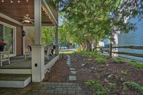 a front porch of a house with trees and a sidewalk at Downtown Charlevoix Duplex half Mi to Lake Michigan in Charlevoix