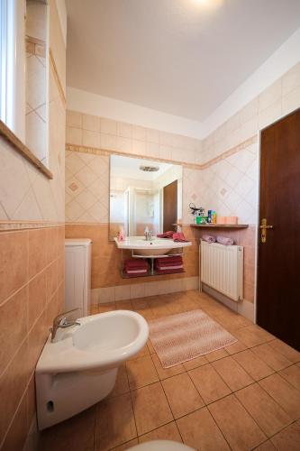a bathroom with a sink and a toilet in it at Giorgio - Fontana in Zadar