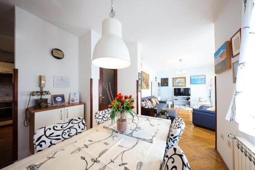 a dining room and living room with a table and chairs at Giorgio - Fontana in Zadar
