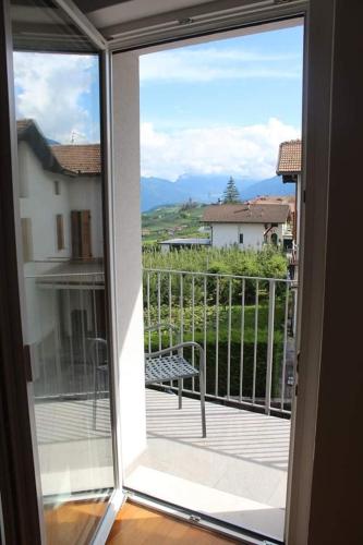 a sliding glass door with a view of a balcony at Orizzonti d'Anaunia in Tassullo