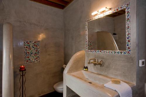 a bathroom with a sink and a mirror at Casa Lindos in Lindos