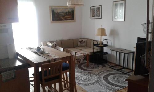 a living room with a table and a couch at Ferienwohnung - Apartement - Hotel Klippitz Nordost in Reichenfels