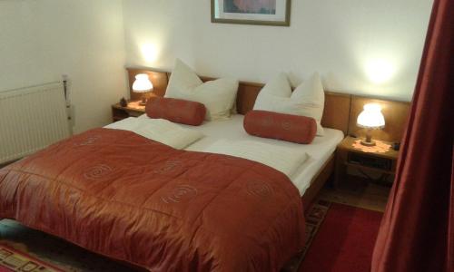 a bedroom with a large bed with two lamps on tables at Ferienwohnung - Apartement - Hotel Klippitz Nordost in Reichenfels