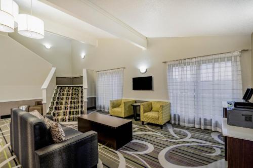 a living room with a couch and chairs and a tv at La Quinta Inn by Wyndham El Dorado in El Dorado