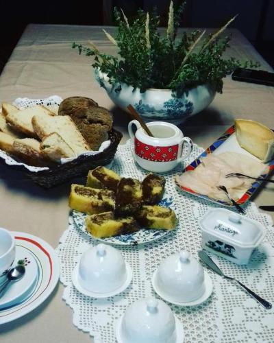 a table with a plate of bread and a cup of coffee at Old House in Monsanto