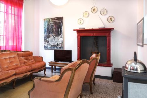 a living room with a couch and a fireplace at Cascina Scanna in Cisliano