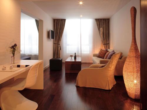 a living room with a couch and a guitar at Adriana Hvar Spa Hotel in Hvar