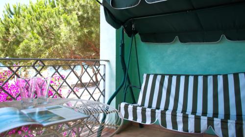 a table and a chair on a balcony at Sardinianworld - Sardinian Stone House in Torre Grande