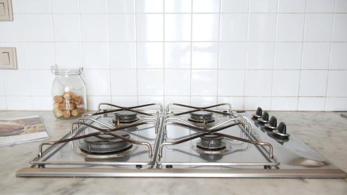 a stove top oven sitting on top of a kitchen counter at Sardinianworld - Sardinian Stone House in Torre Grande