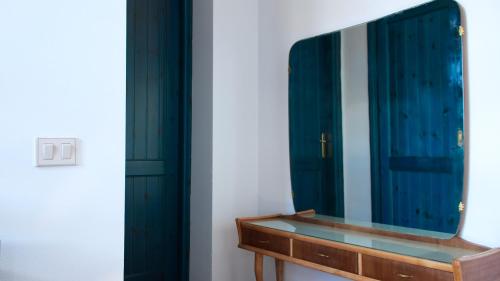a bathroom with a mirror and a wooden sink at Sardinianworld - Sardinian Stone House in Torre Grande