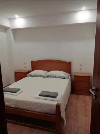 a bedroom with a large bed with two pillows at Casa Morgado in Braga