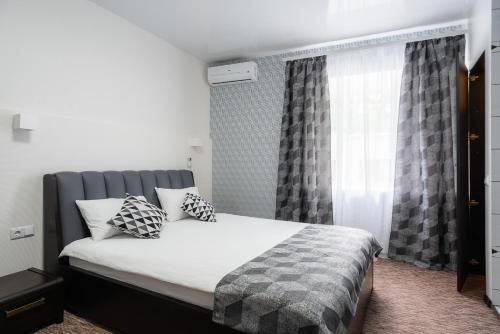 a bedroom with a bed and a window at Rhombus Hotel in Luts'k