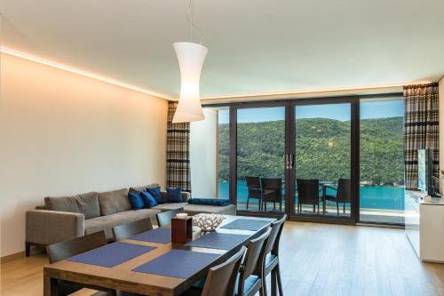 a living room with a couch and a table at Park Hill Residences in Rabac